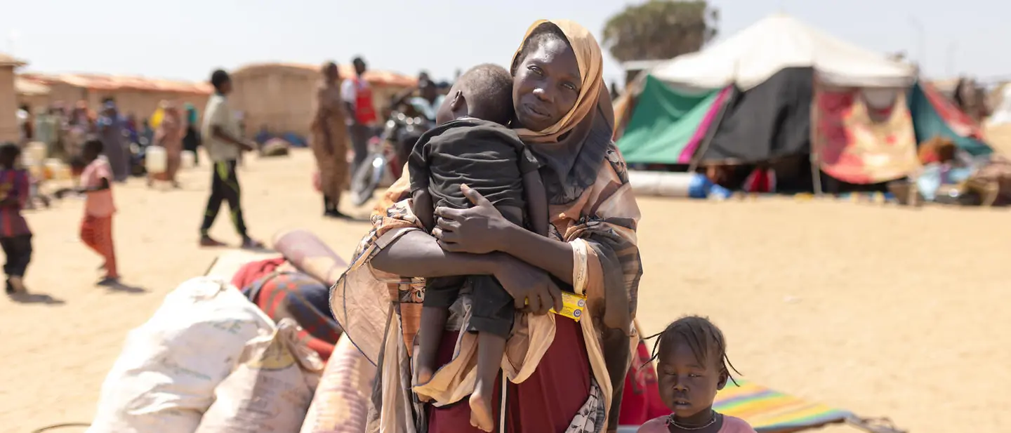 Displaced Sudanese family illustrating the Sudan funding cuts humanitarian crisis
