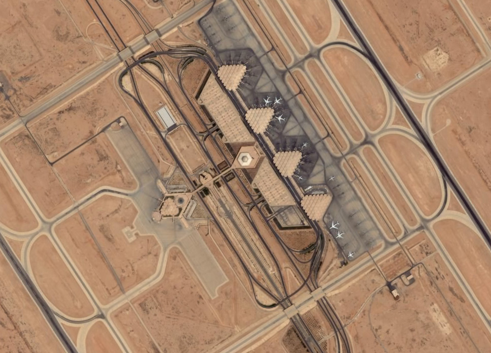 King Khalid International Airport in Riyadh seen from above, its terminals and runways surrounded by desert