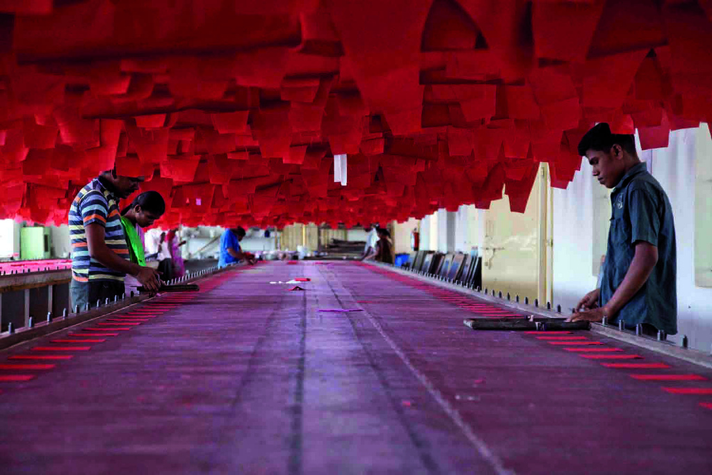 India manufacturing PMI October 2026 — workers at a garment factory in Tirupur, Tamil Nadu, as factory output rises but manufacturing hiring slows