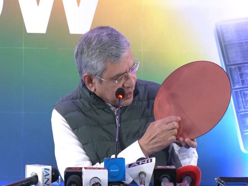 Union Minister Ashwini Vaishnaw at a semiconductor event holding an unveiled chip