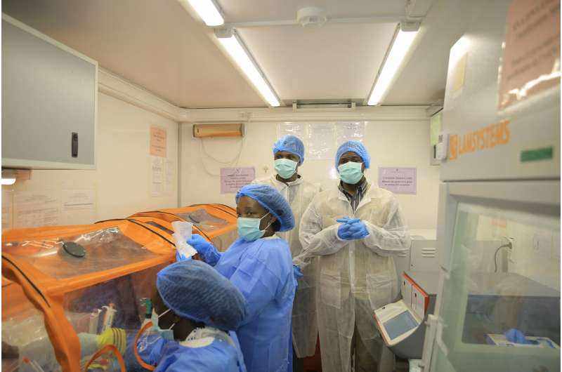 Medical workers operate a mobile laboratory for rapid Ebola testing in Butembo, North Kivu