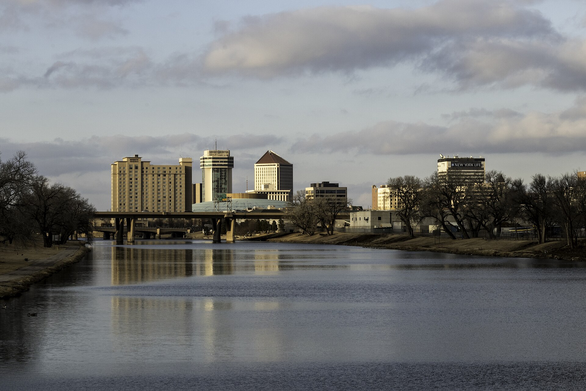Wichita Kansas skyline along the Arkansas River — the city is mourning two killed in the Wichita youth soccer game crash