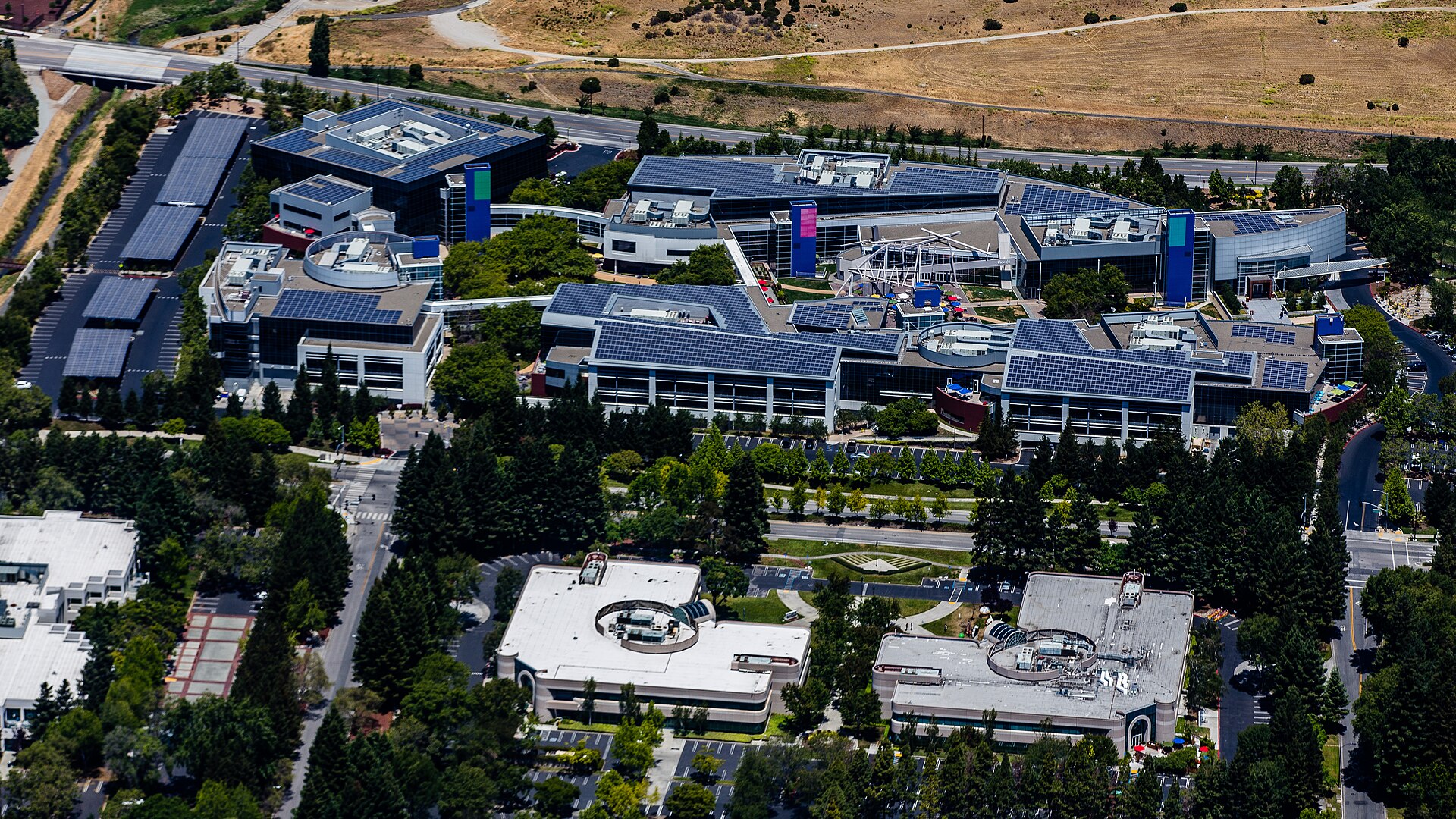 Aerial view of the Googleplex, Google's headquarters campus in Mountain View, California, with solar-panel rooftops