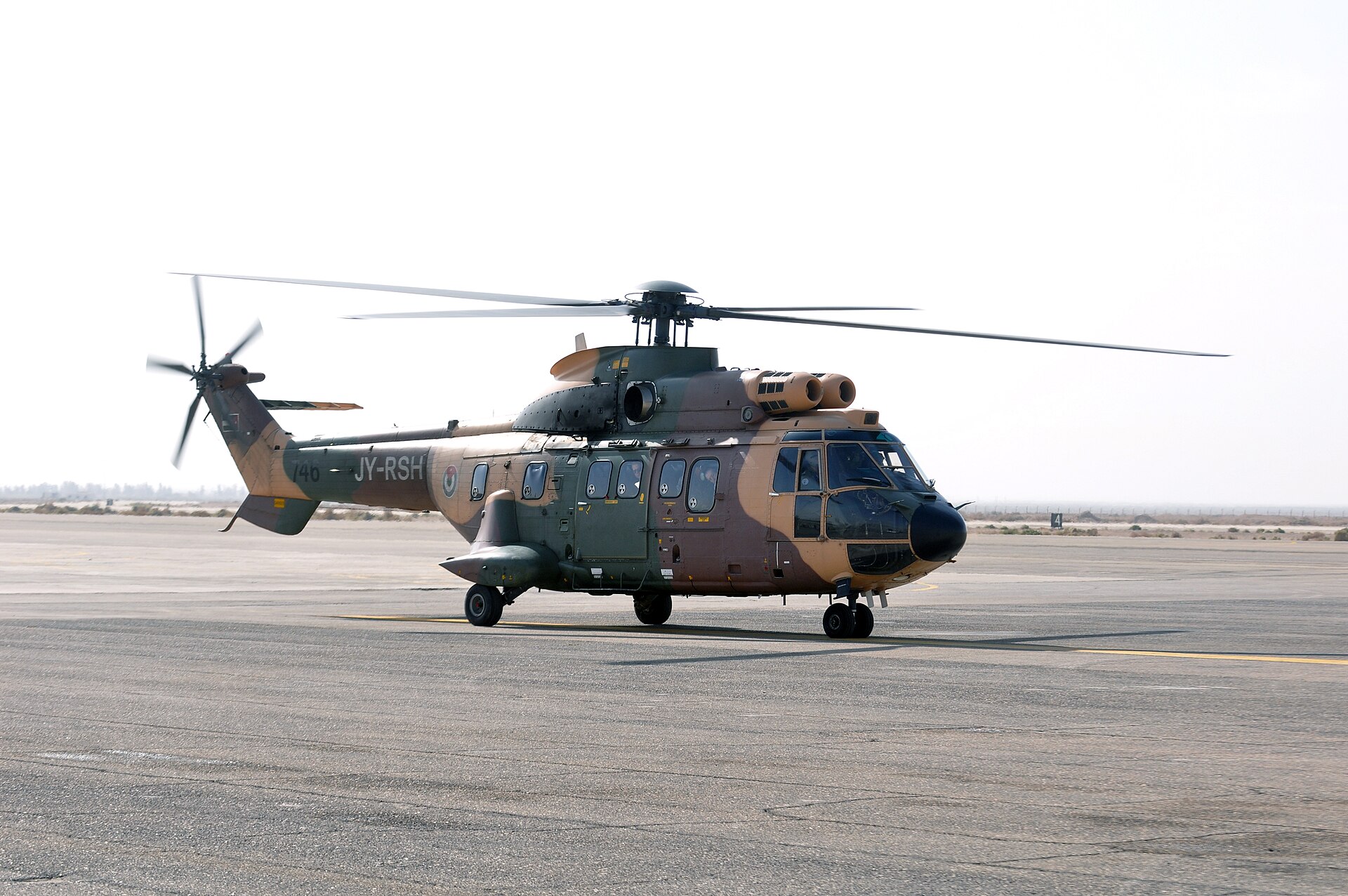 A camouflaged Royal Jordanian Air Force helicopter, tail JY-RSH, on a tarmac in Jordan — file photo
