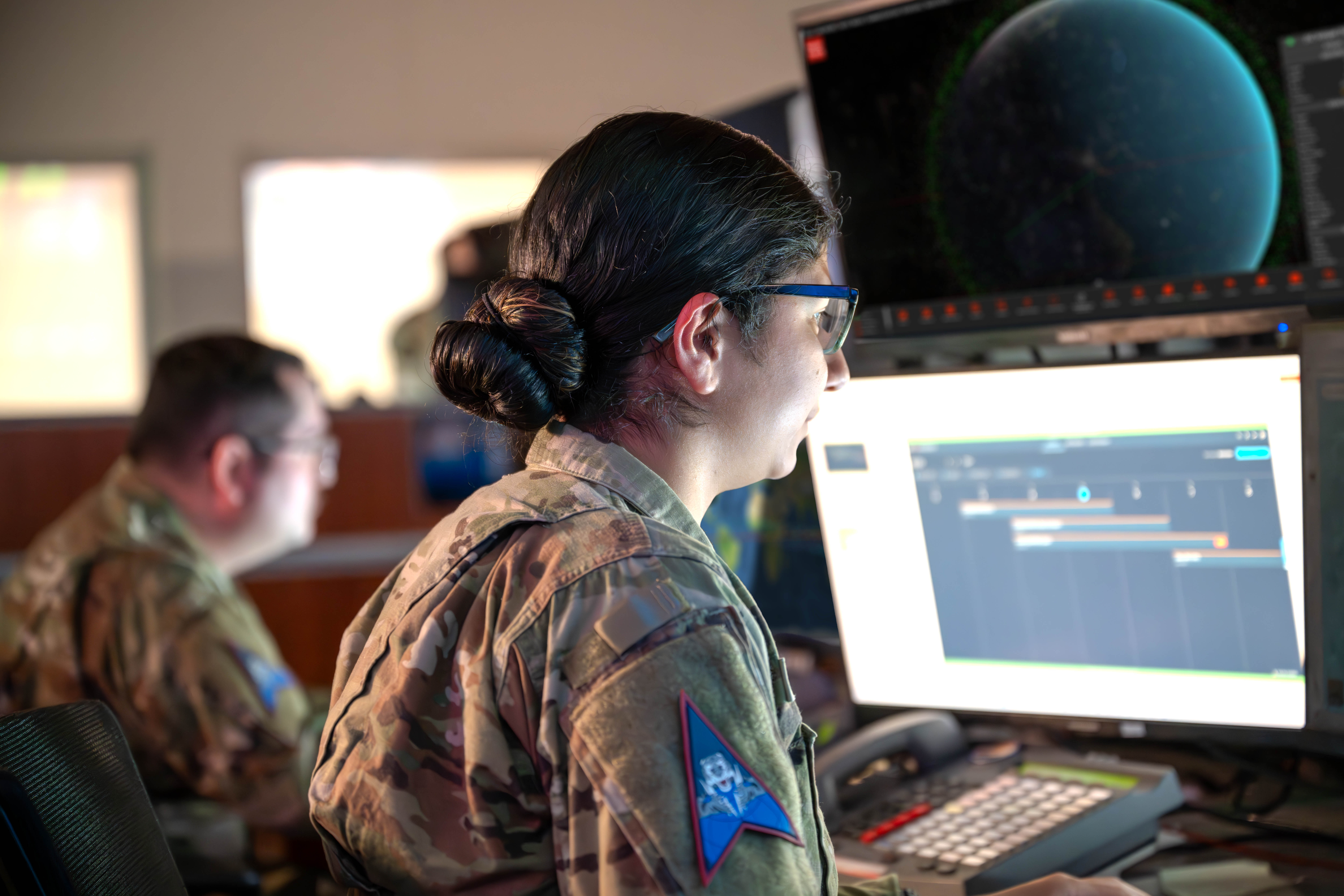 An operations centre watch floor with rows of monitors