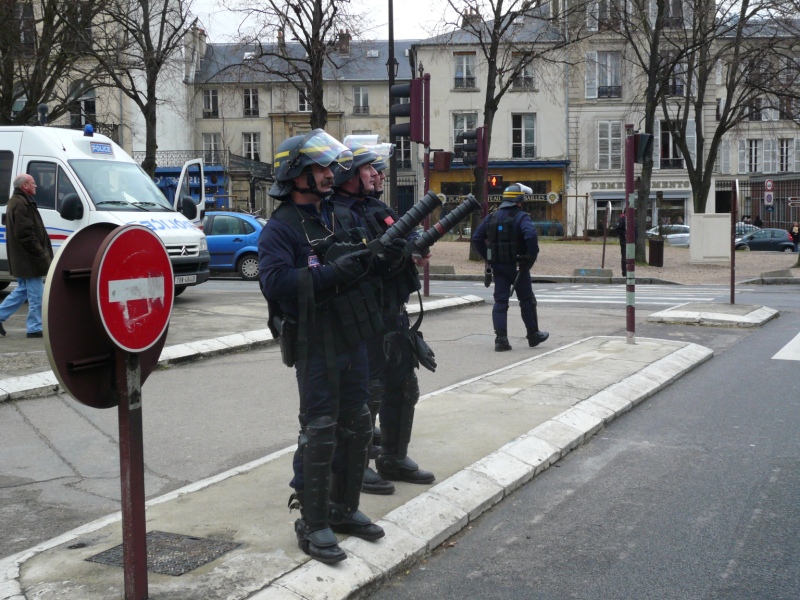 CRS riot police officers holding grenade launchers in France — a police stun grenade maimed a 15-year-old during the Lens lycée protest