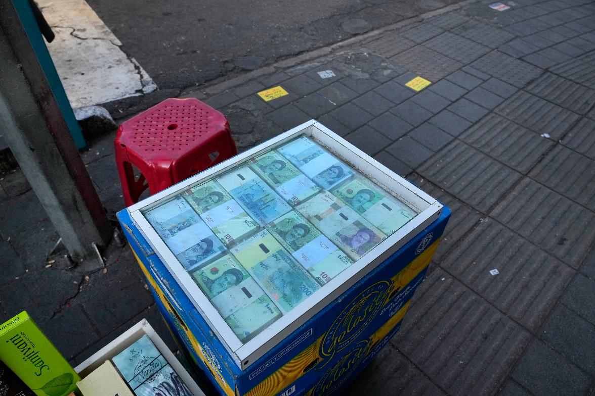 Iranian currency traders monitor exchange rates in central Tehran