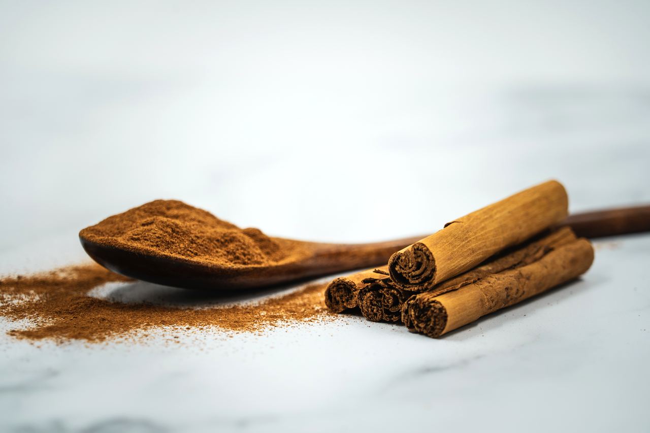 Ground cinnamon powder with a cinnamon stick — an illustrative photo of ground cinnamon, not the recalled Lior product