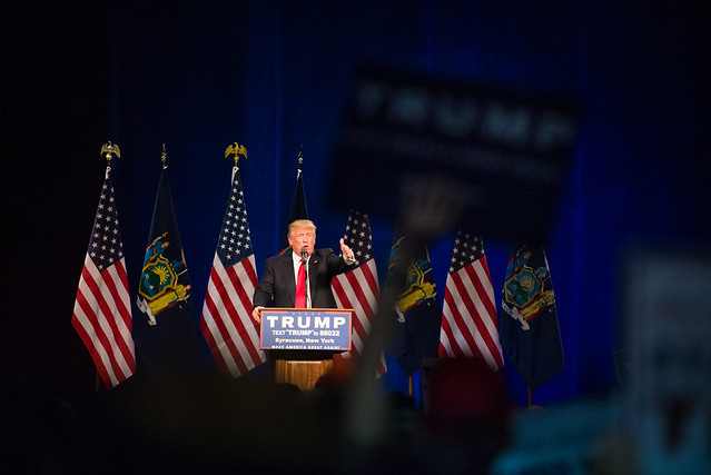 Donald Trump seen through the crowd at a Syracuse rally in 2016, historical context for the Trump rally Syracuse October 9