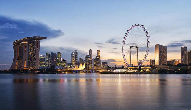 Singapore's Marina Bay; the Forbes Global CEO Conference heard bubble warnings from Ray Dalio and AI-risk caution from Temasek's chief investment officer