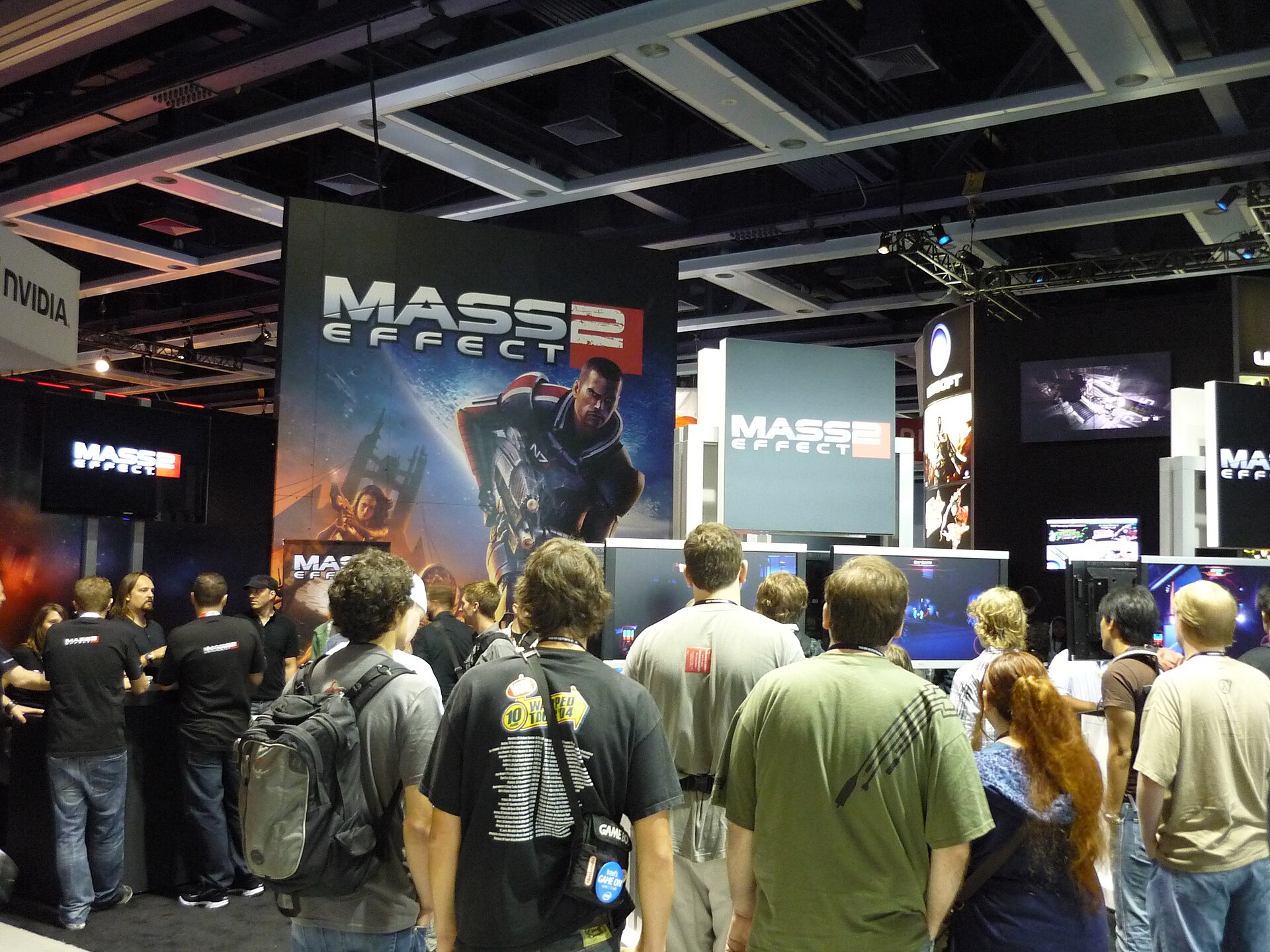 Mass Effect 2 booth at PAX 2009 with fans gathered around Commander Shepard artwork