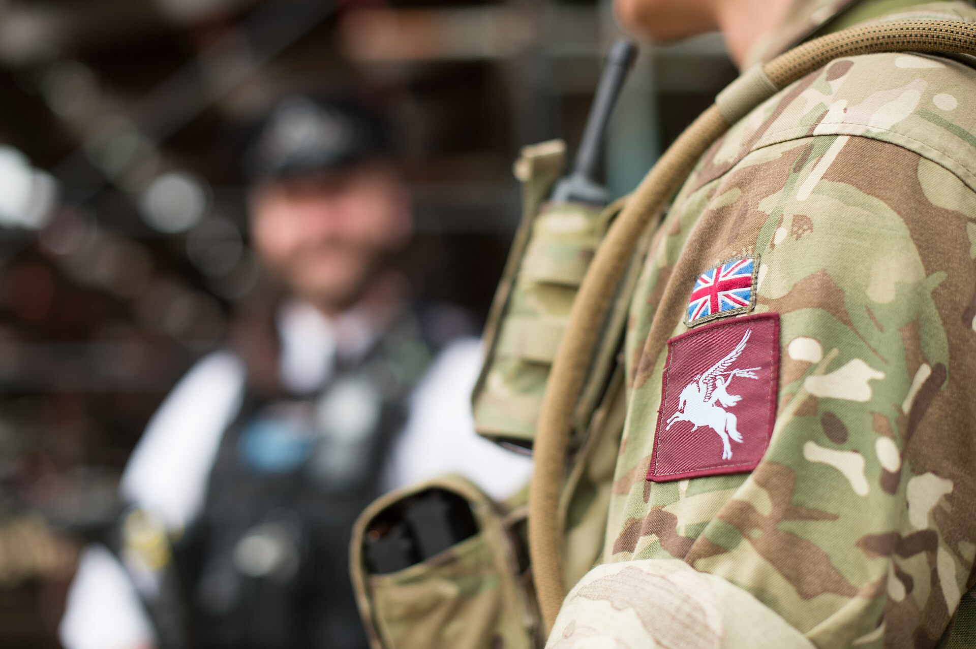 A British soldier on guard duty alongside a police officer during Operation Temperer