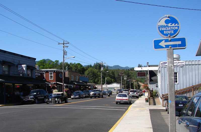 Tsunami evacuation route sign at an intersection in Nehalem, Oregon