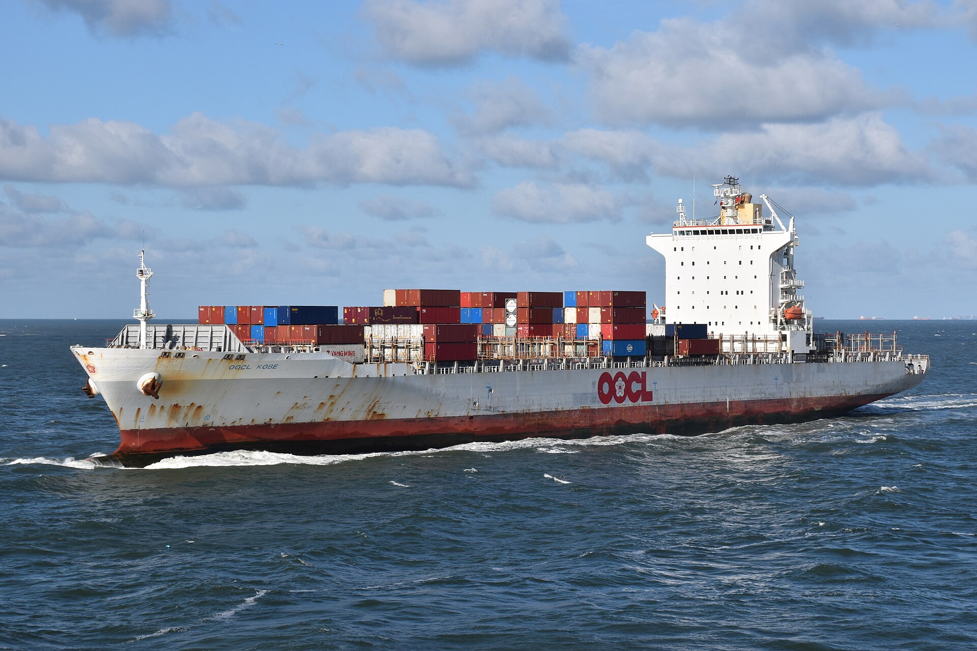 Japan PMI October 2026 — the container ship OOCL Kobe under way, as new export business grows at its softest pace in four months