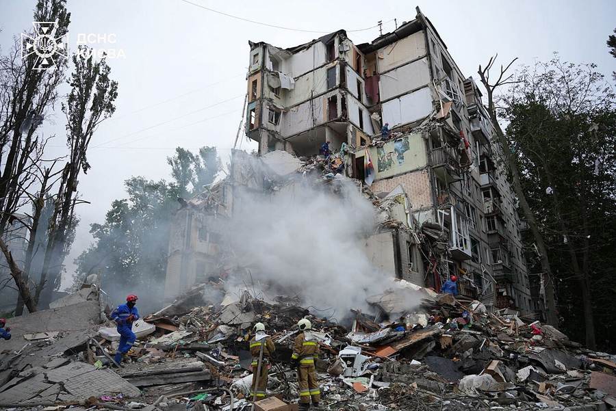 Emergency workers amid the ruins of an apartment building in Kyiv's Sviatoshynskyi district after a Russian strike on July 31, 2025