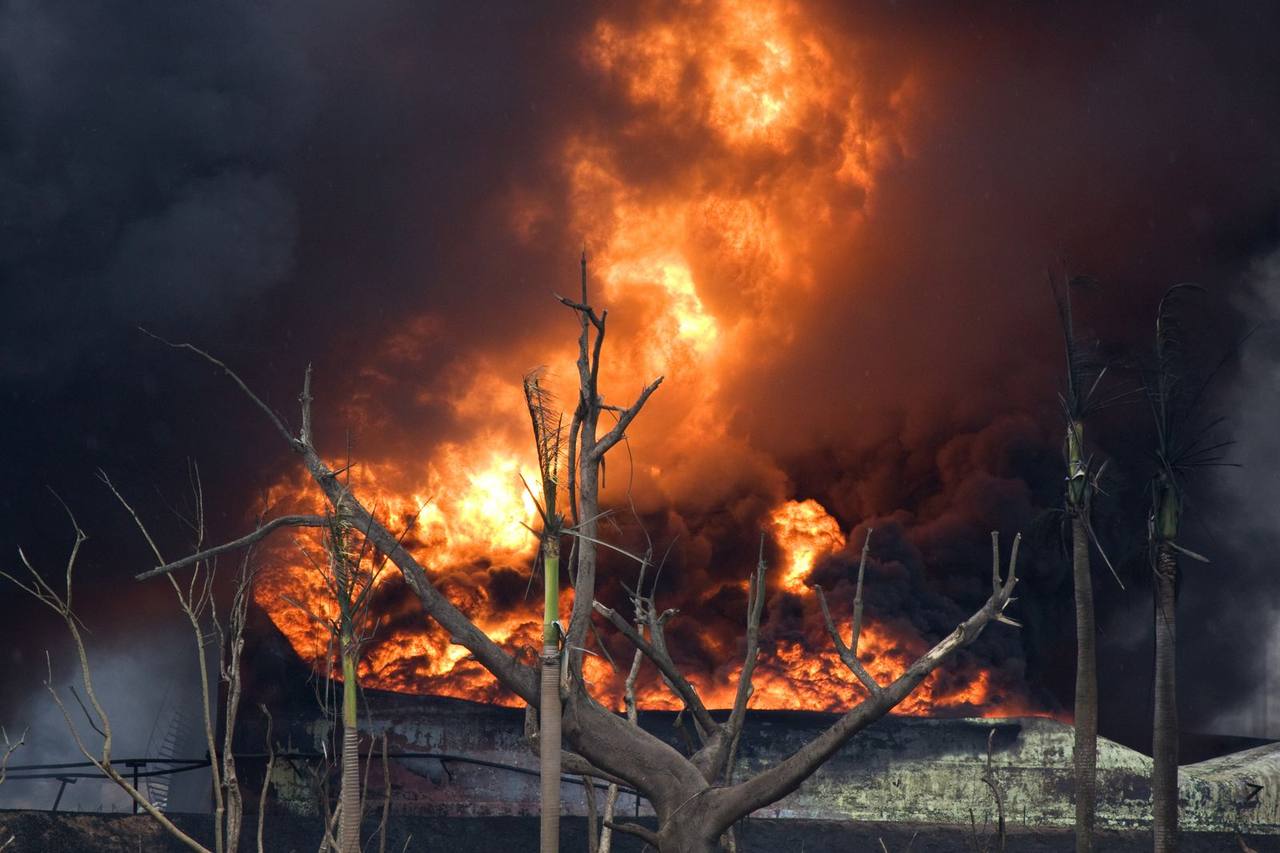 Fuel depot fire with flames and black smoke &mdash; the Sudan RSF drone strike on the Umm Alila fuel depot in El Gezira, September 27, 2026
