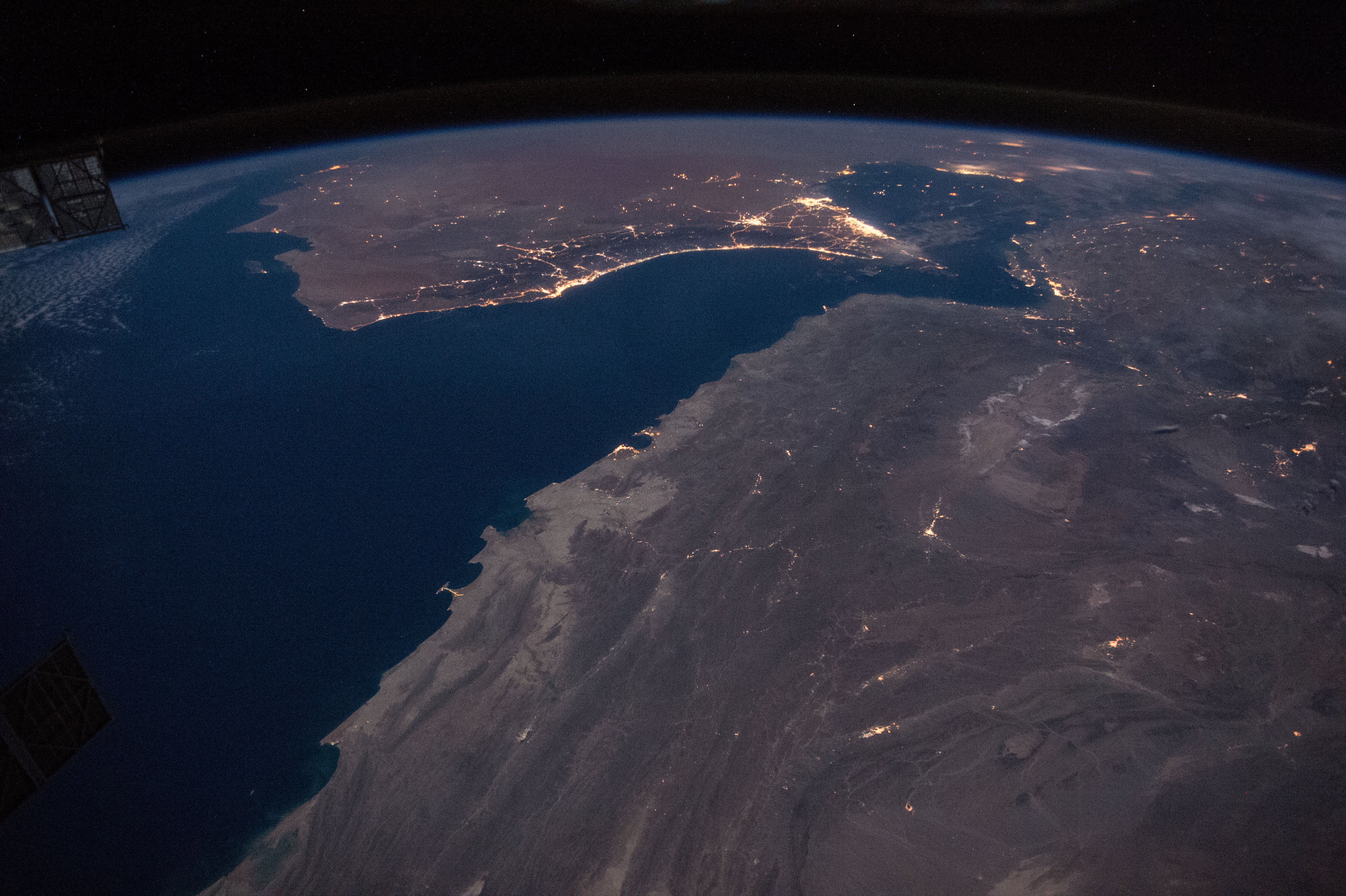 Iran undersea cables Hormuz — the Gulf of Oman and Strait of Hormuz at night from the International Space Station