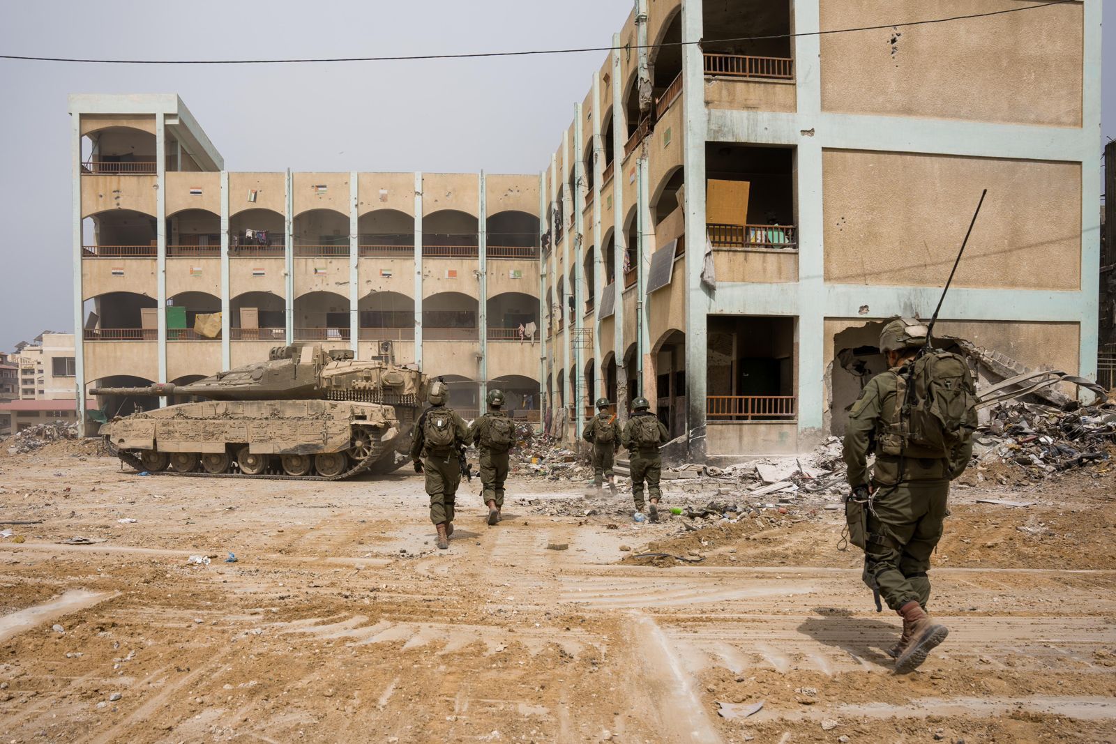 Israeli soldiers and a tank beside a damaged building in Gaza City during the April 2024 operation at the Al-Shifa hospital complex — file photo