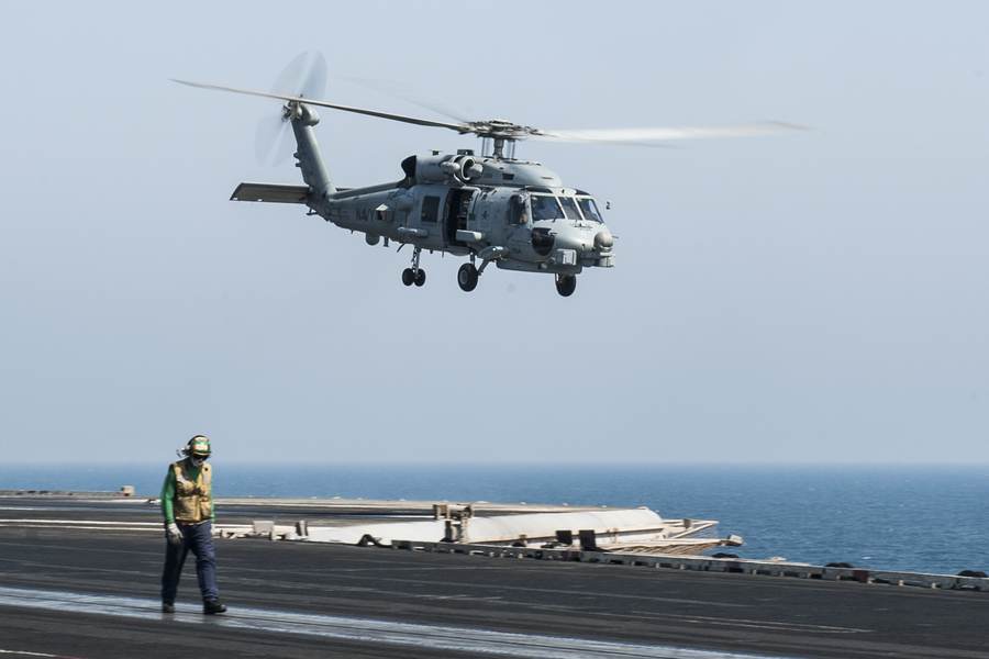 An MH-60R Sea Hawk helicopter takes off from USS George H.W. Bush in the Arabian Gulf