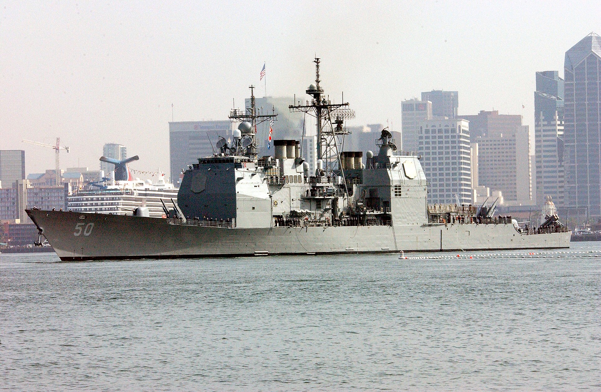 The San Diego skyline with a U.S. Navy cruiser in the foreground — San Diego is home to Naval Base San Diego