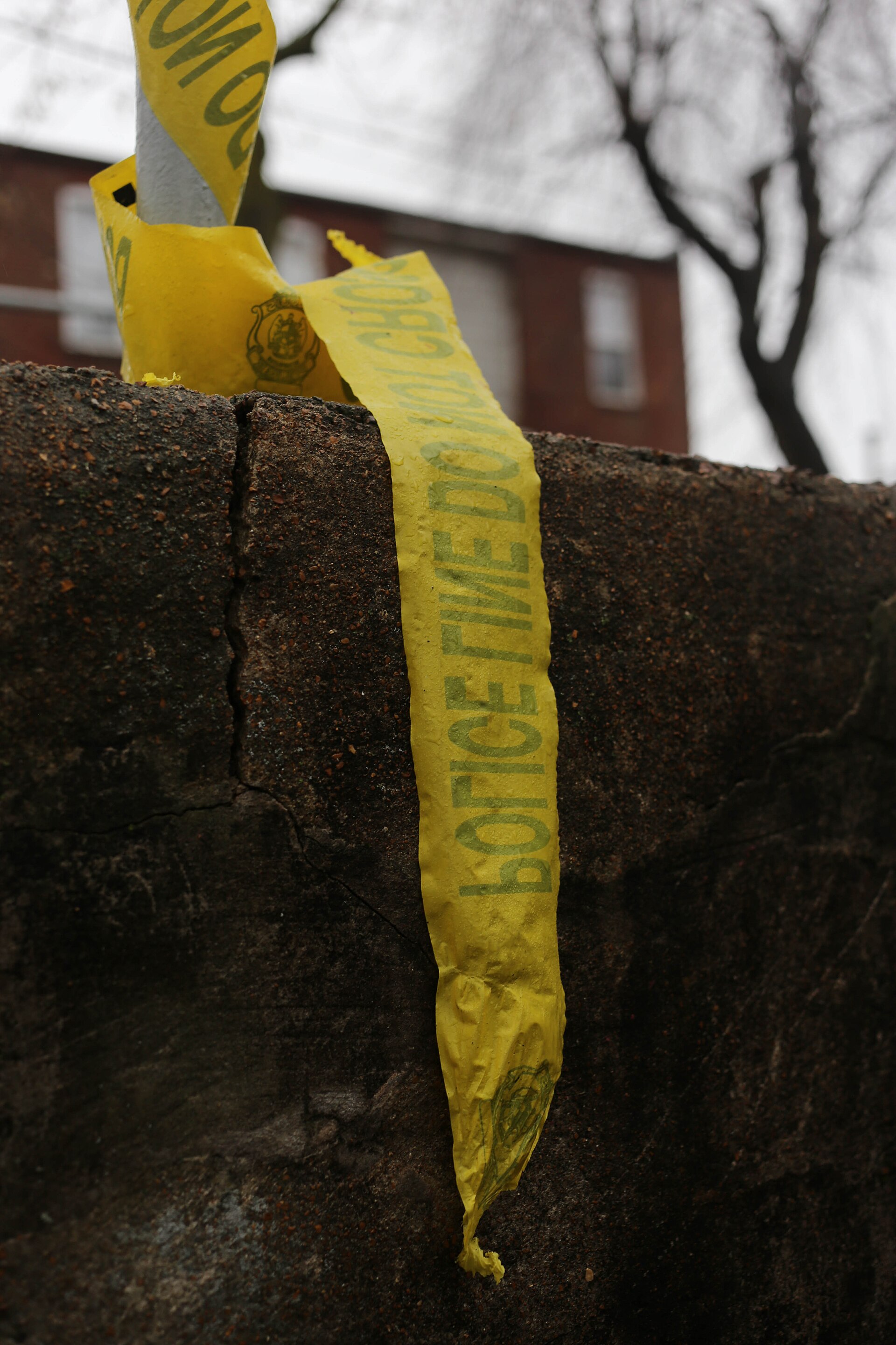 Yellow police line tape at a cordoned scene