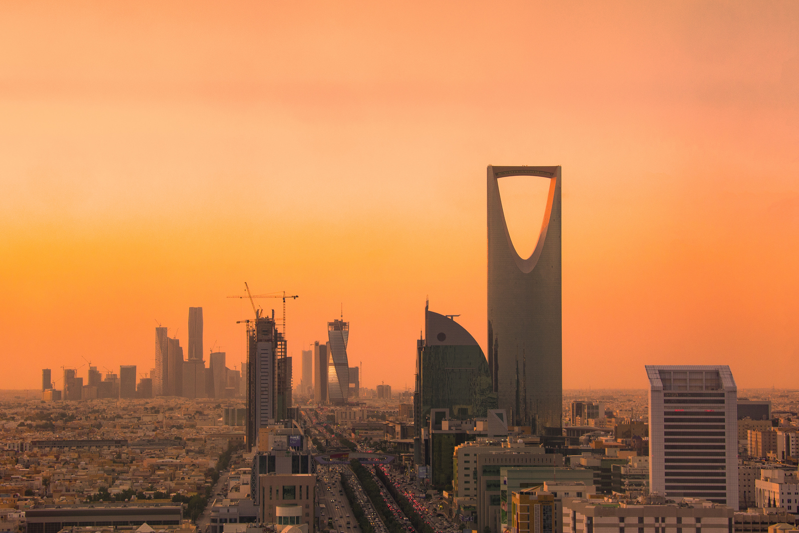 The Riyadh skyline at sunset, dominated by the Kingdom Centre tower