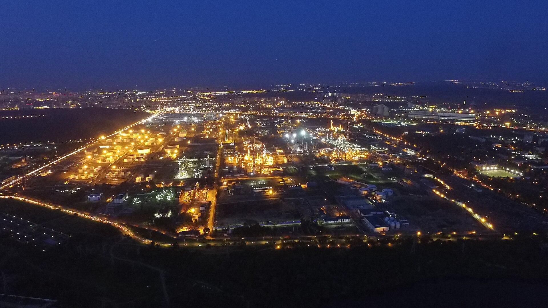 A Russian oil refinery lit up at night, seen from the air — a file photograph of the Moscow oil refinery, not the Novokuybyshevsk plant struck on October 30