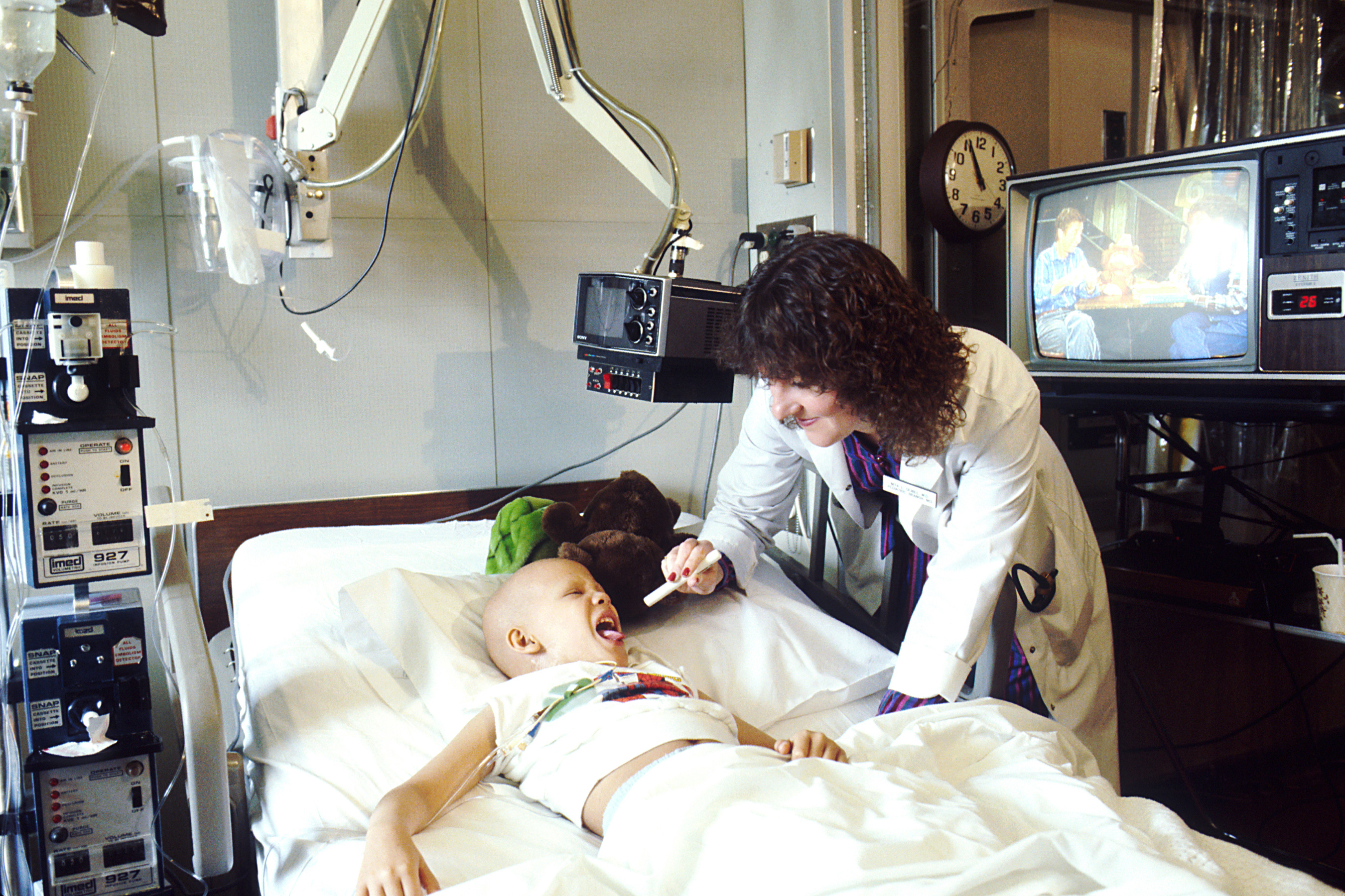 Doctor examining a child patient in a hospital — employer health coverage costs KFF survey 2026, file photo