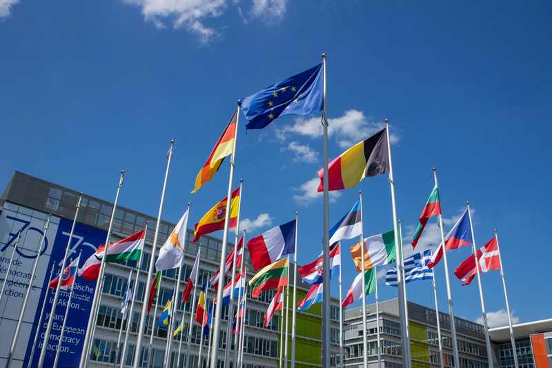 European Union flags in Brussels; EU tax measures require unanimous Council approval, and several capitals already oppose the CORE levy