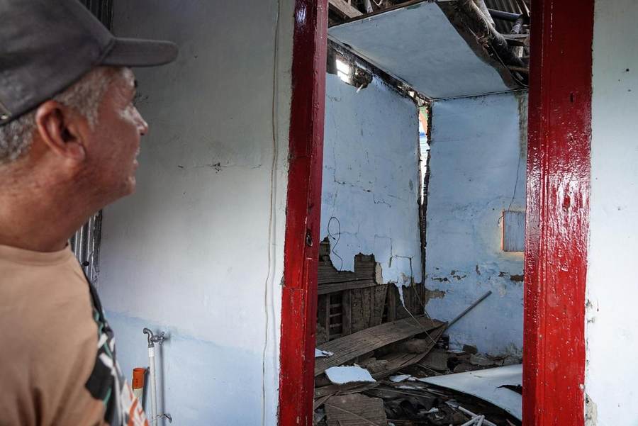 Rescue volunteer standing amid earthquake ruins in western Colombia after the August 10, 2026 quake