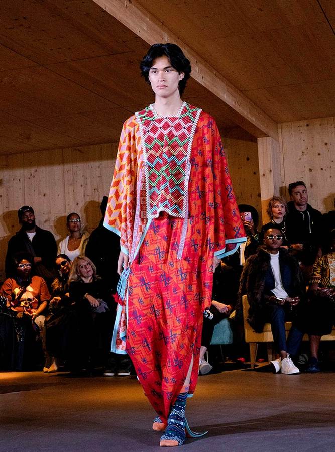 Maxhosa Africa model in a patterned knit ensemble during a Paris runway presentation