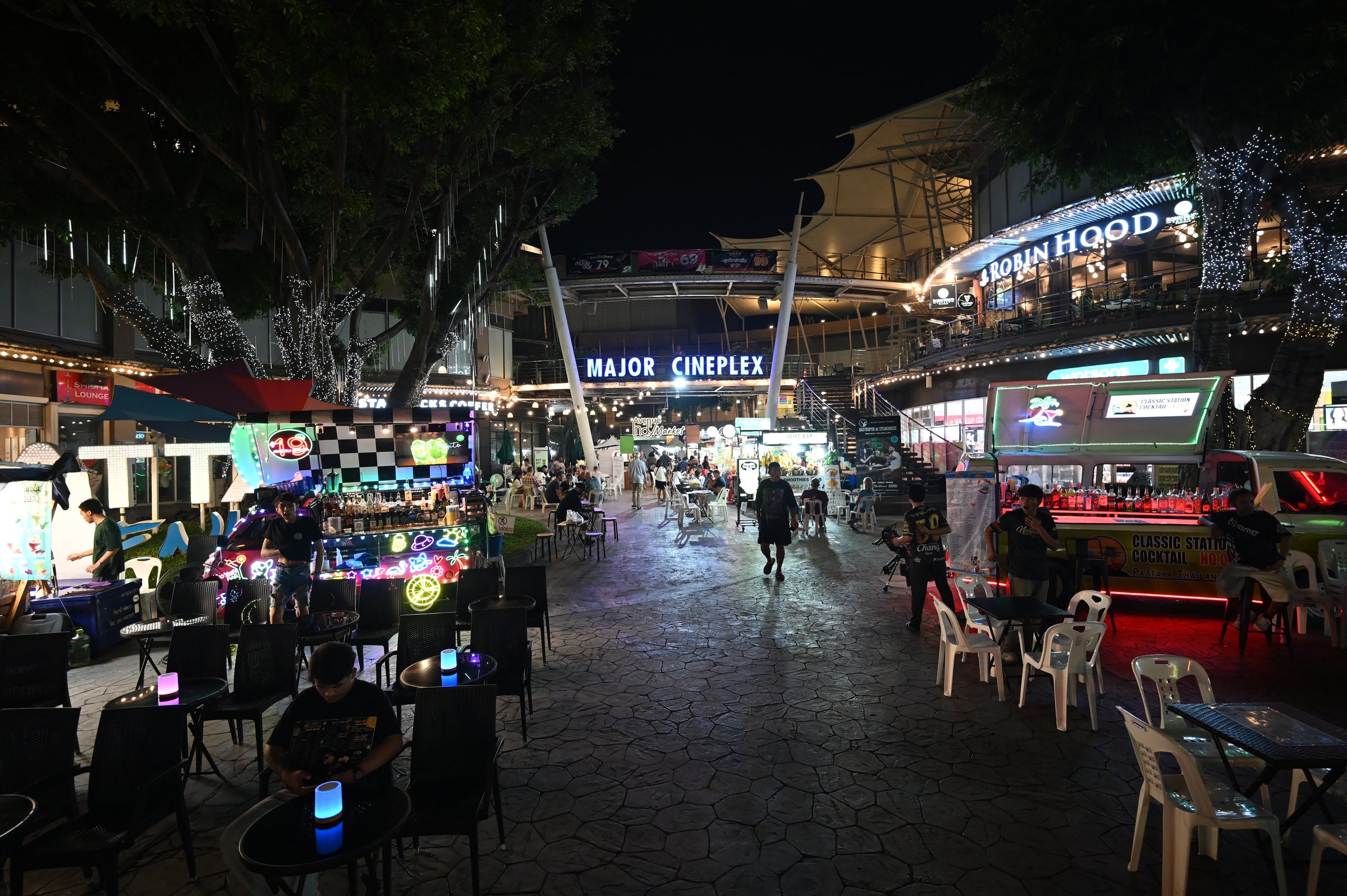 A cineplex sign glowing at night in Pattaya, Thailand