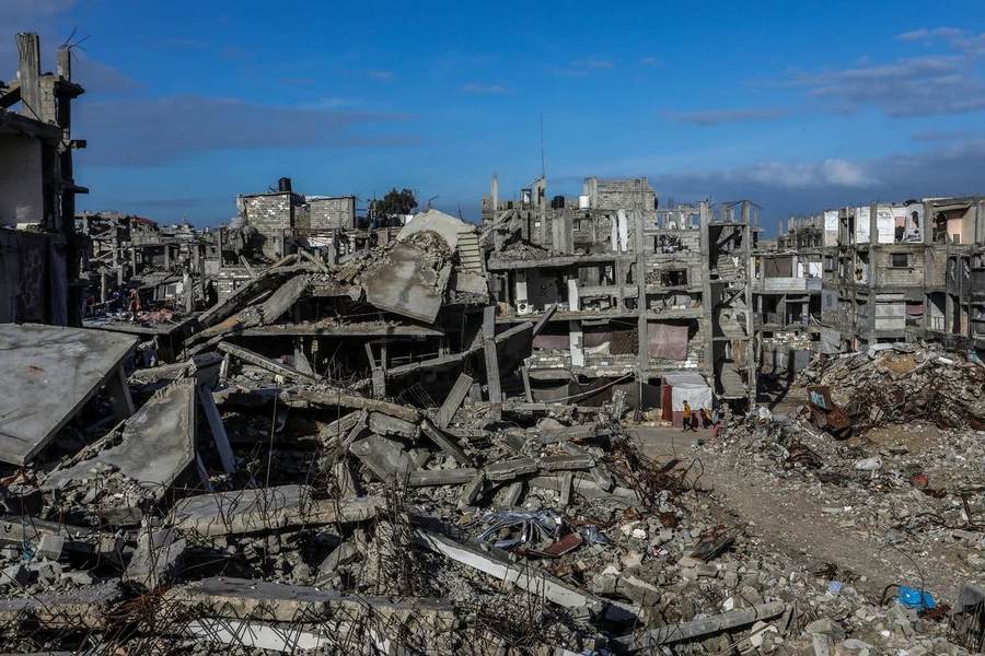 Residents moving among destroyed buildings in Khan Younis amid continuing Gaza ceasefire violations