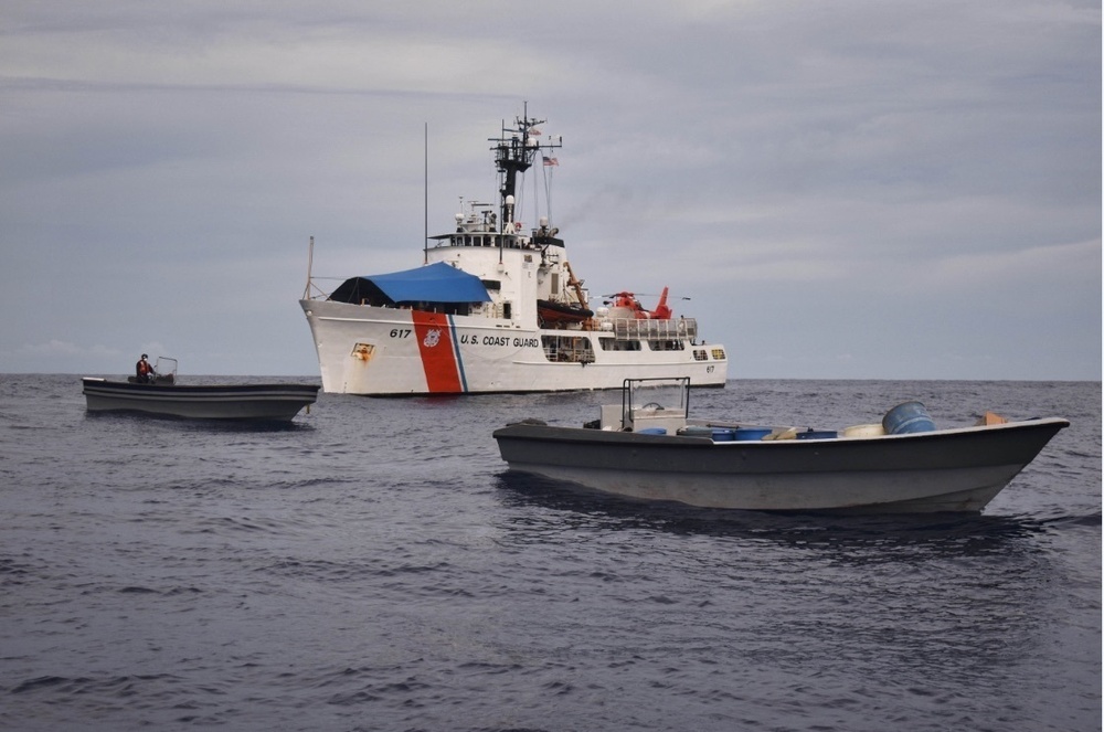 U.S. Coast Guard Cutter Vigilant near two smaller boats during a 2020 Caribbean counter-drug interdiction