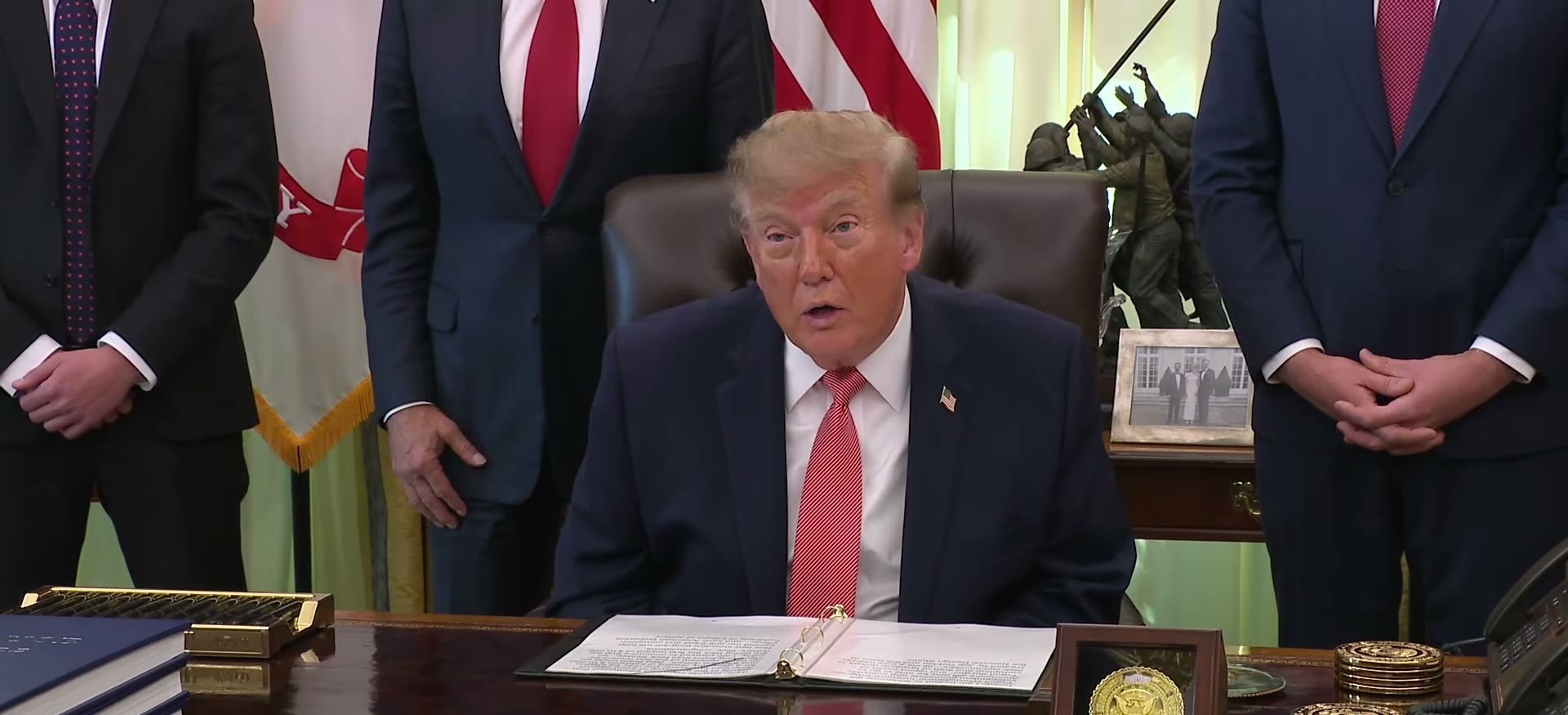 President Donald Trump seated at the Resolute desk in the Oval Office announcing the Fraud Whistleblower Incentive Program on October 20, 2026