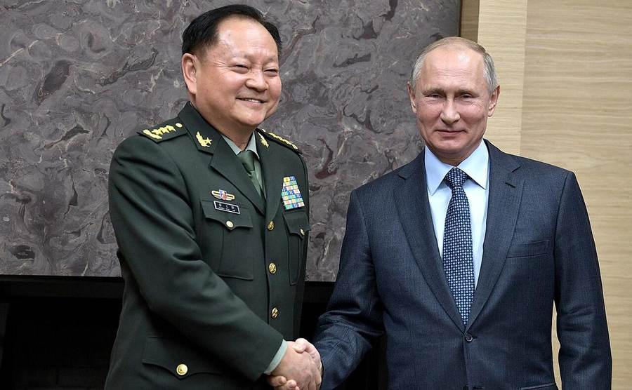 Chinese general Zhang Youxia shaking hands with Russian President Vladimir Putin in Moscow in 2017