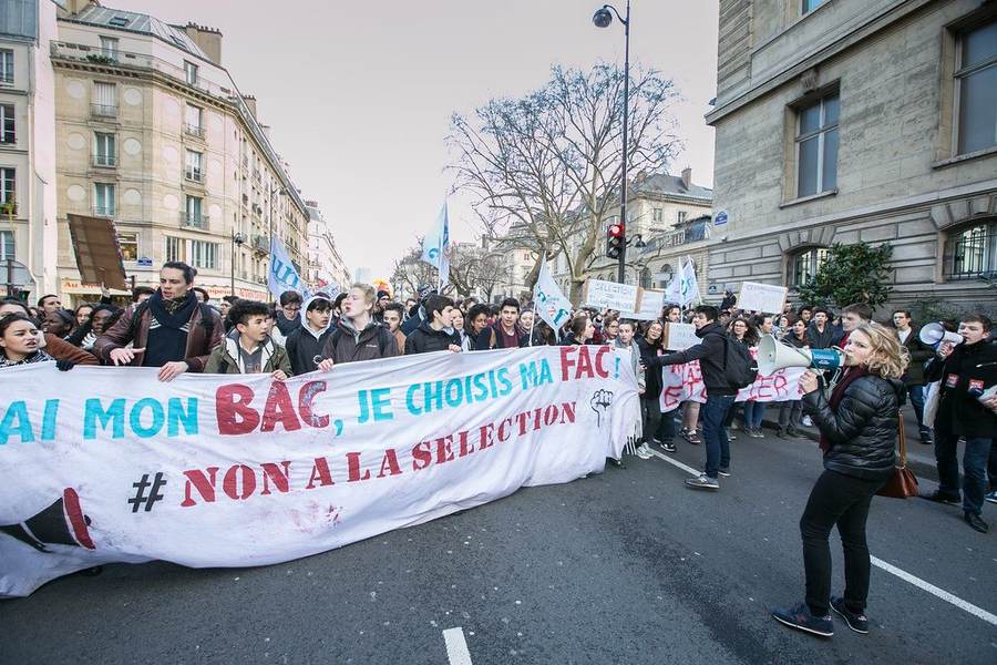 French lycée students marching behind a banner during a school protest in Paris