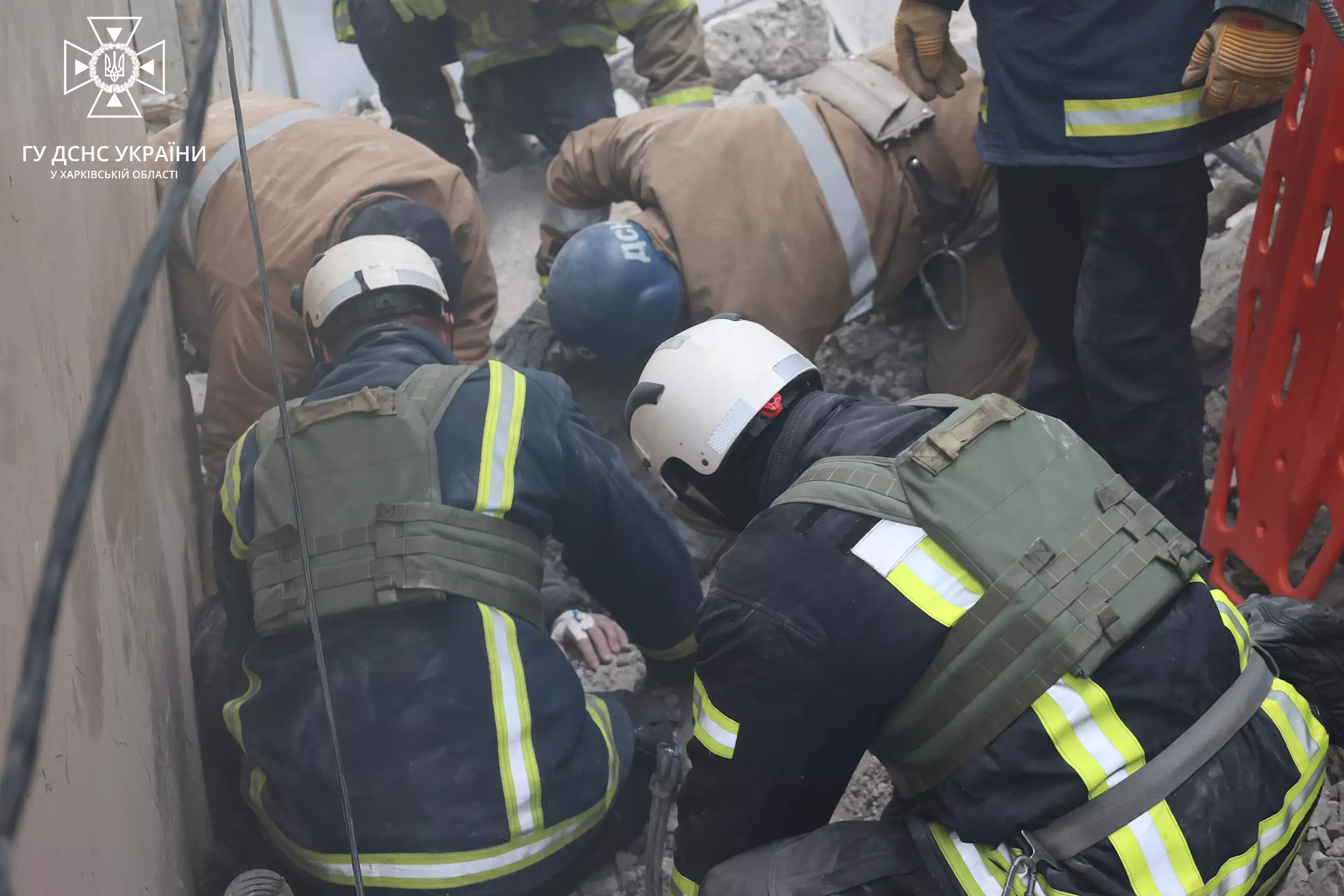 Ukrainian emergency workers searching rubble after a Russian missile attack on Kharkiv on December 29, 2023