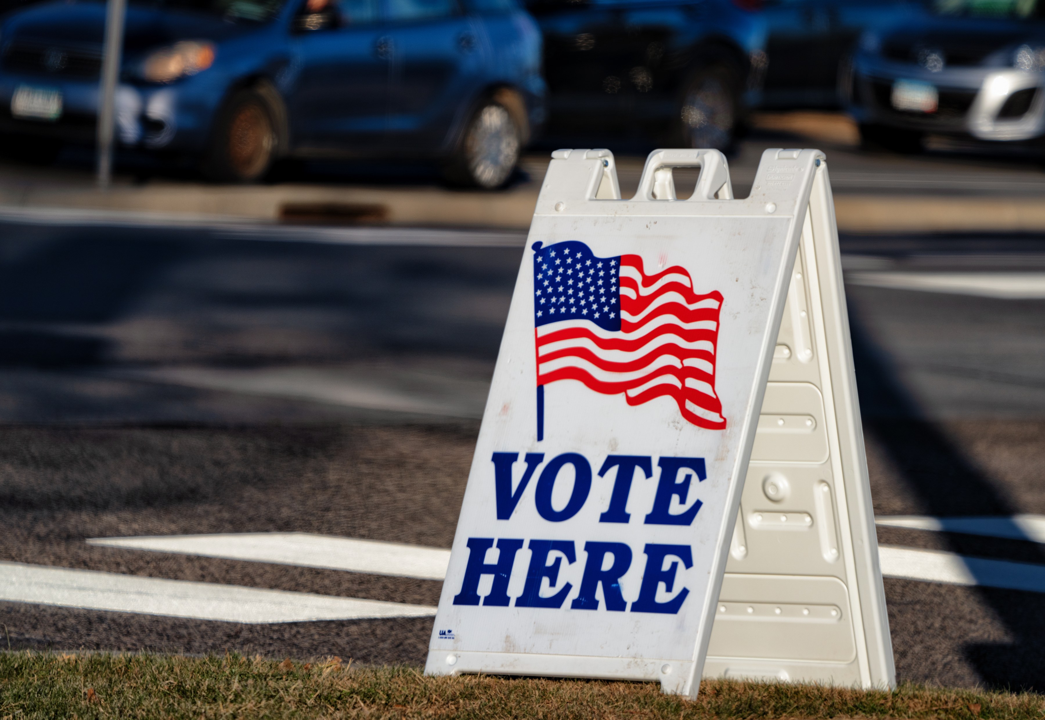 DOJ election monitors 2026 — a Vote Here sign at a US polling place ahead of the November midterms