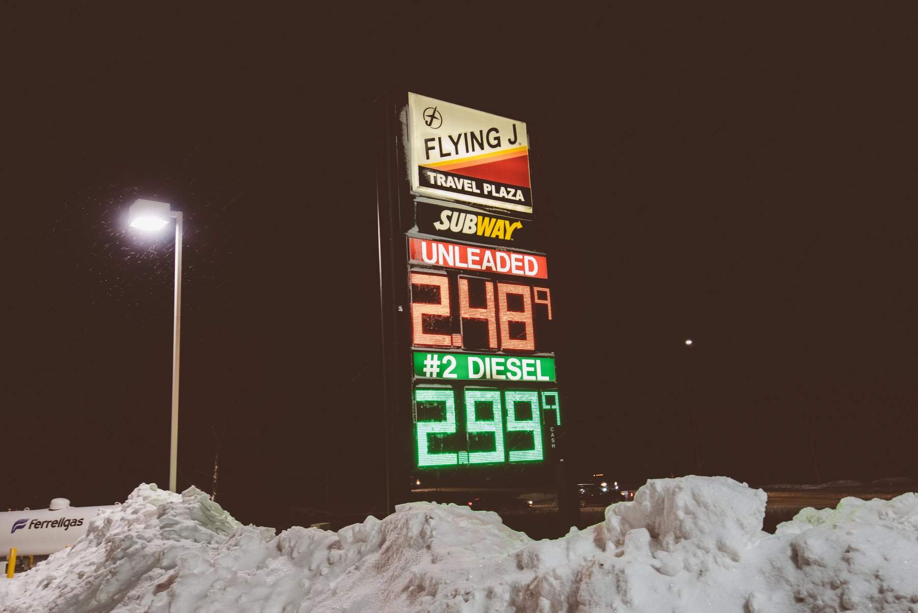 Gasoline and diesel price sign illustrating how Trump Iran war energy prices reach motorists and freight operators
