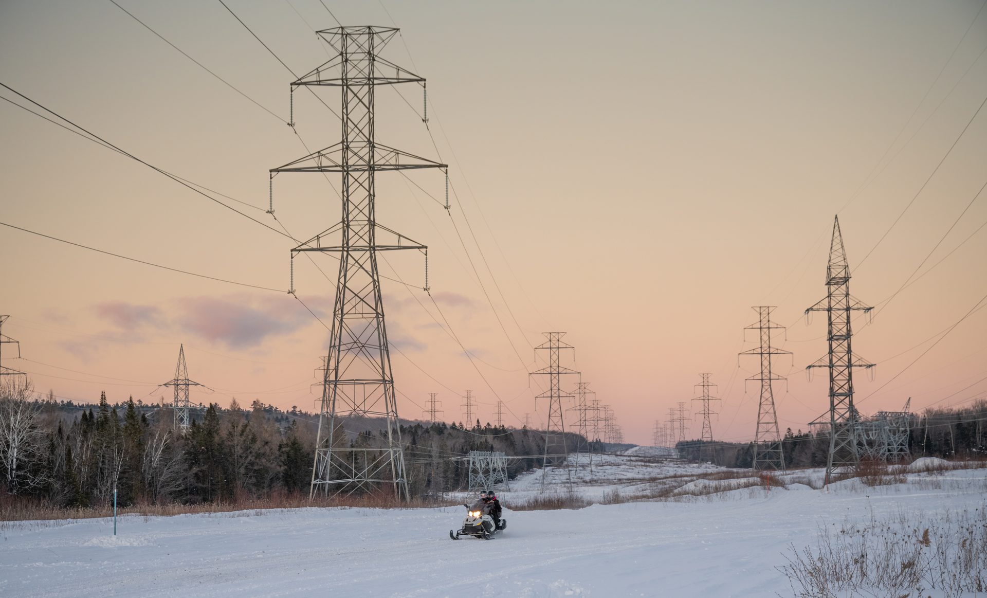 Electricity pylons at sunset — power and capital, not chips, may become the main constraint on AI data centre expansion
