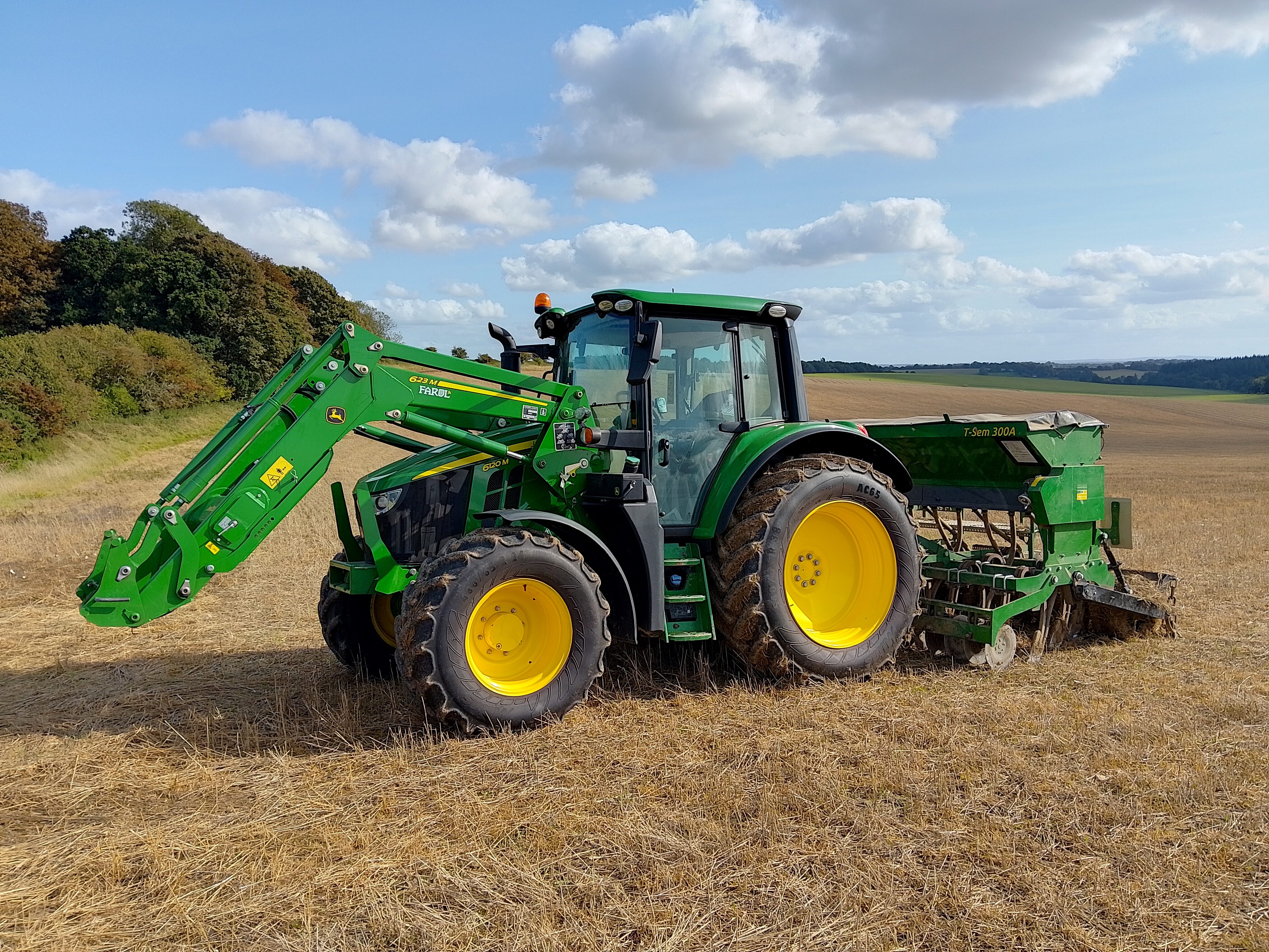 Trump red diesel tax exempt order — a John Deere tractor with a front loader in a farm field, file photo