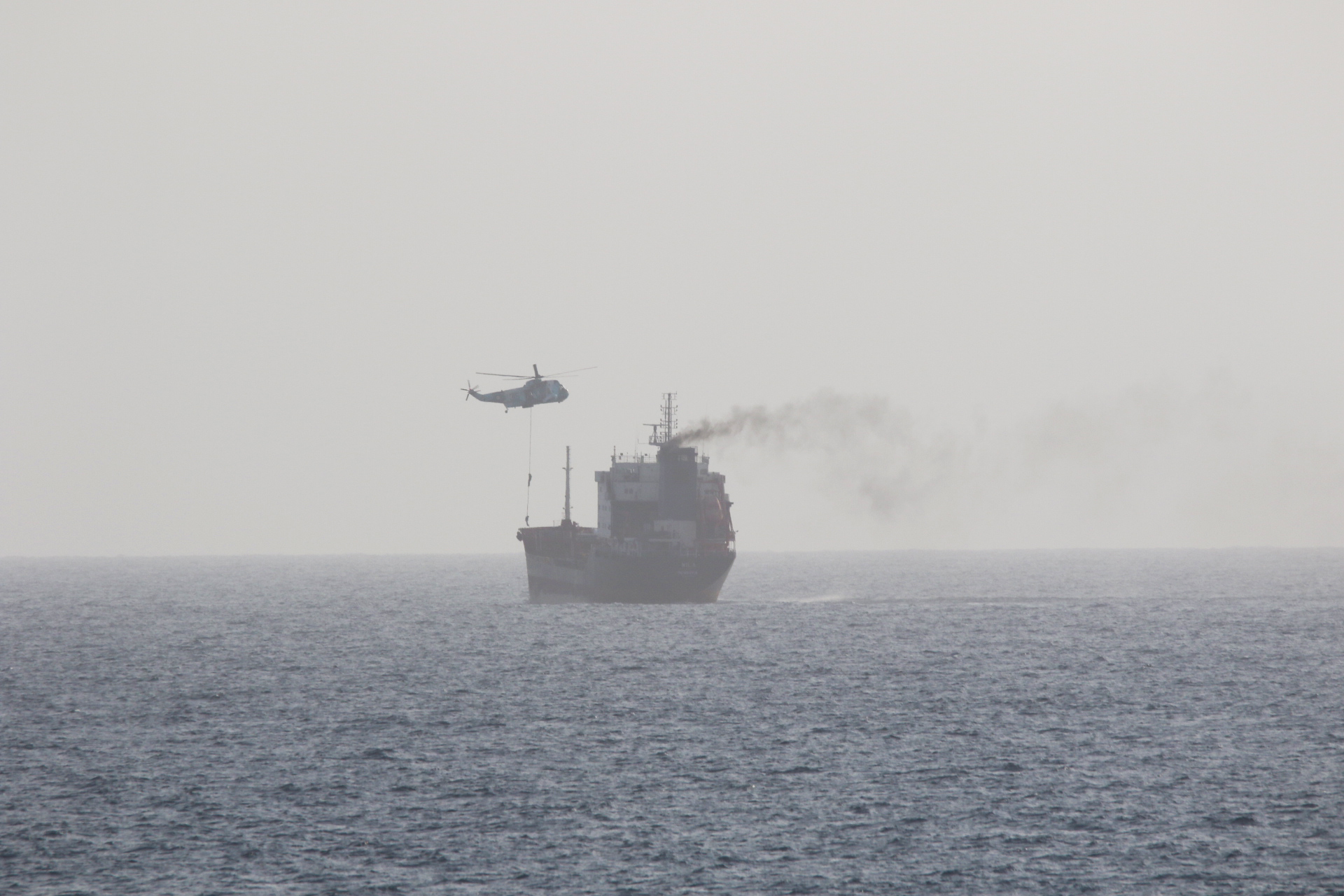 An Iranian helicopter fast-ropes naval personnel onto the tanker MT Wila in August 2020, in a file photograph of an earlier Iranian boarding of a tanker accused over oil transfers — the IRGC says the four vessels it tracked on Wednesday were likewise engaged in illegal oil transfers