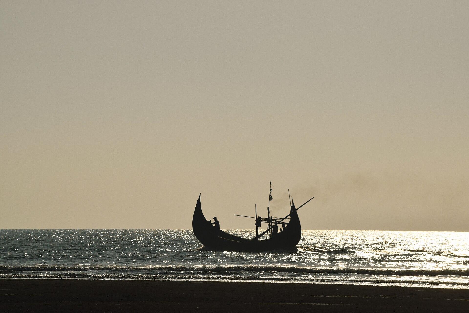 Fishing boats on Cox's Bazar beach in Bangladesh at sunset