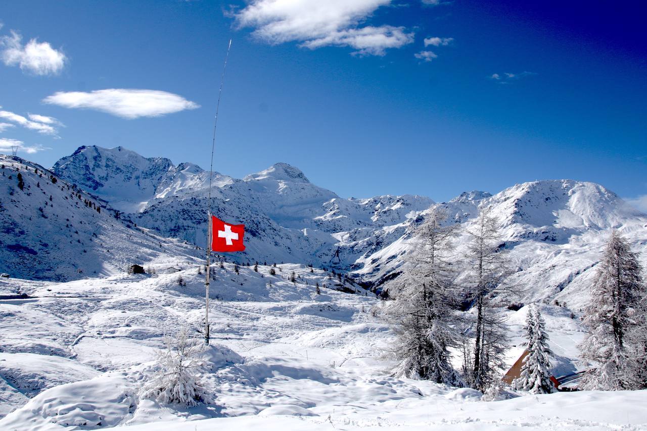 A Swiss flag flying in Bern — voters rejected a constitutional lock on neutrality by about 70 percent on September 27, 2026
