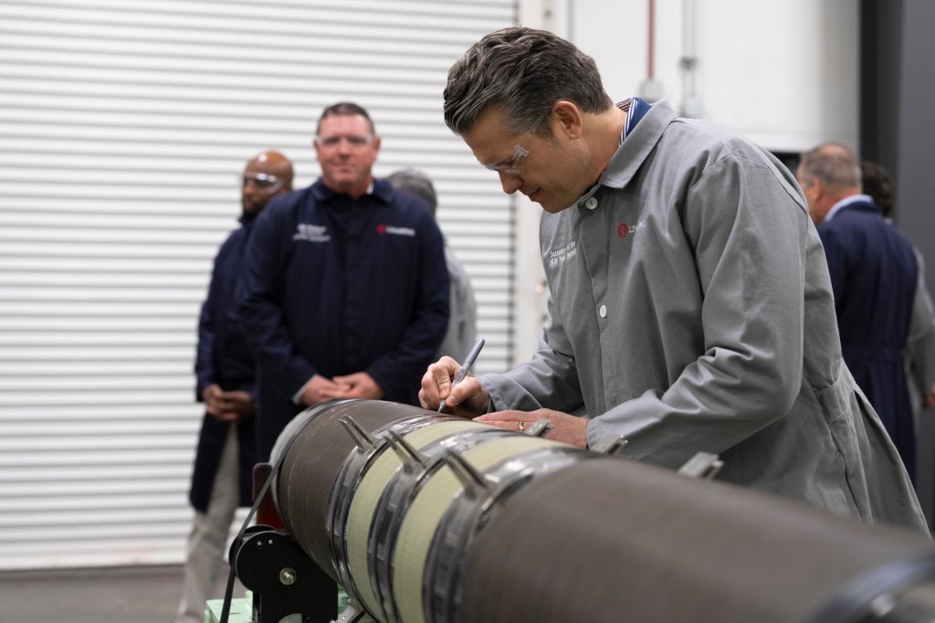 Defense Secretary Pete Hegseth signs a missile component during a visit to a US defense contractor facility in February 2026