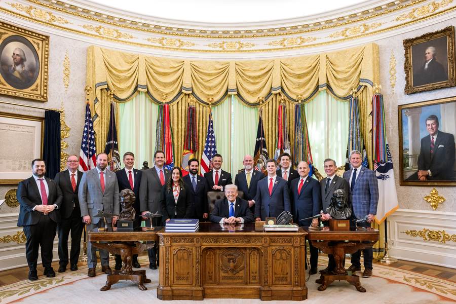 President Donald Trump speaks with lawmakers before signing executive orders in the Oval Office in April 2026