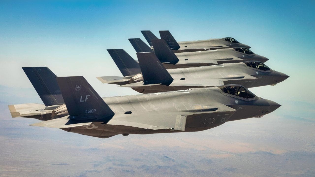 F-35 fighter jets fly in formation — the dual-capable aircraft at the heart of NATO's Steadfast Noon nuclear drill 2026