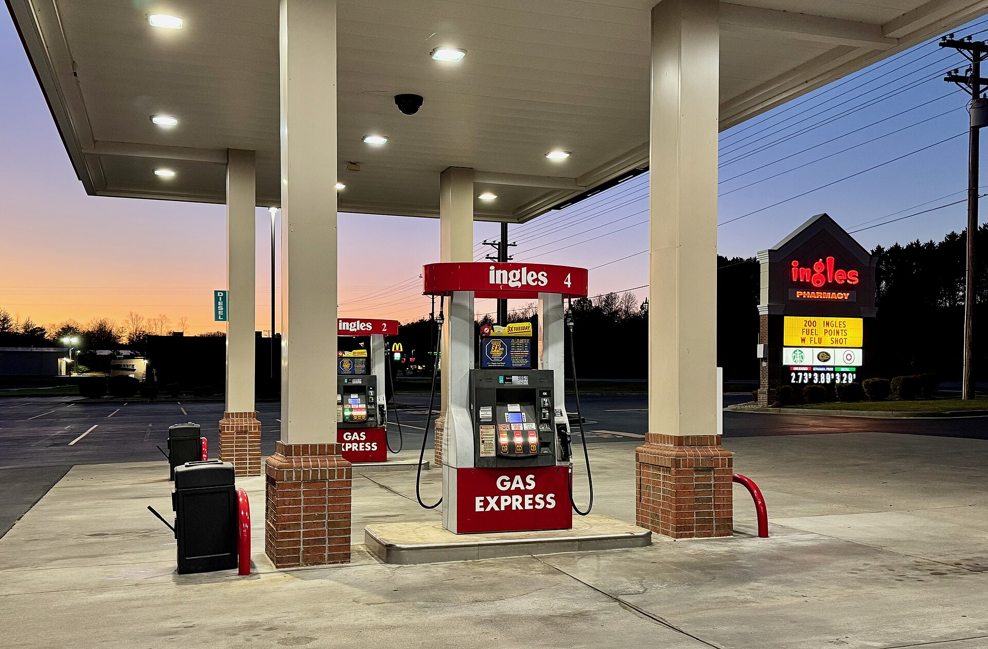 Gasoline pumps at a station in Hayesville North Carolina at sunset — gasoline and energy prices drove the September CPI inflation increase to 3.7 percent